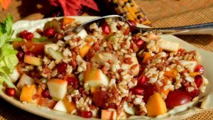 Bountiful Harvest Grain Salad in green serving bowl on gold linen